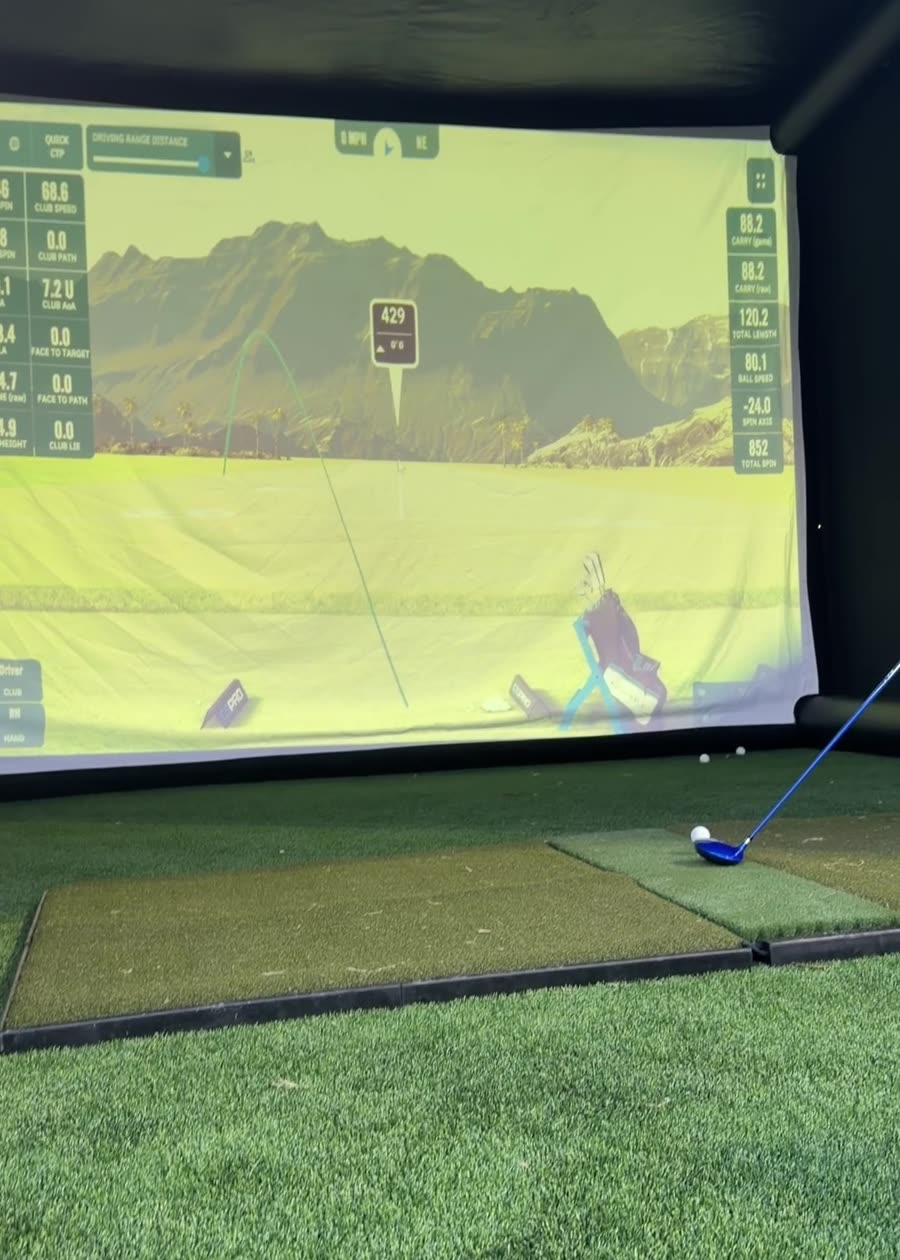 Close-up of the simulator screen with launch monitor stat overlay
